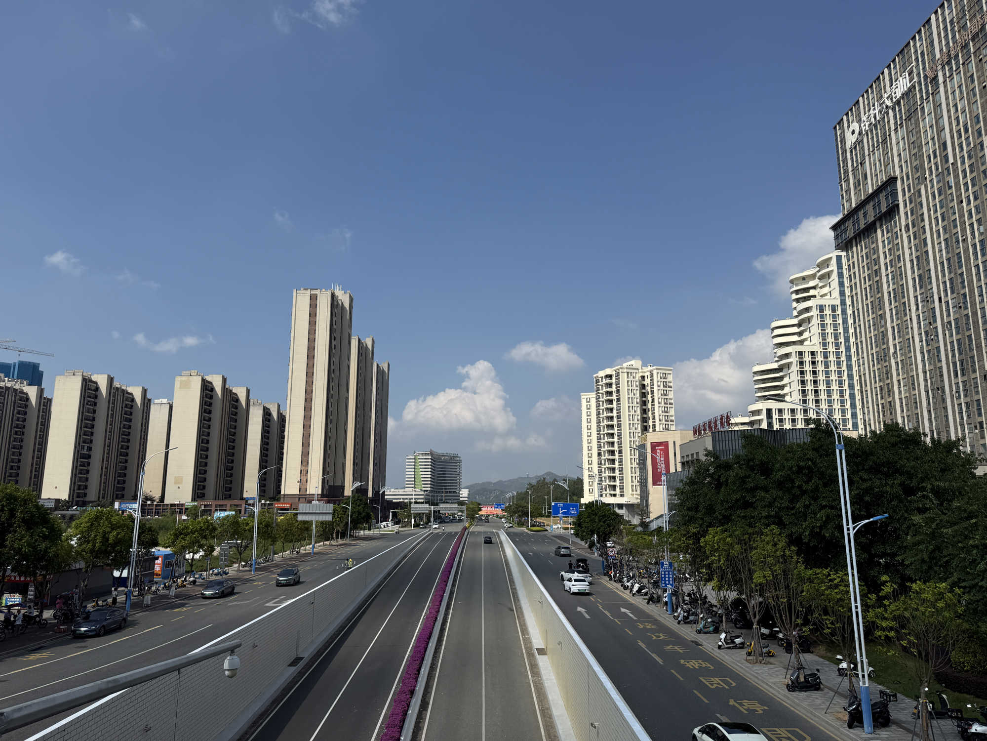 A view of Blue Sky City Avenue Buildings cars m